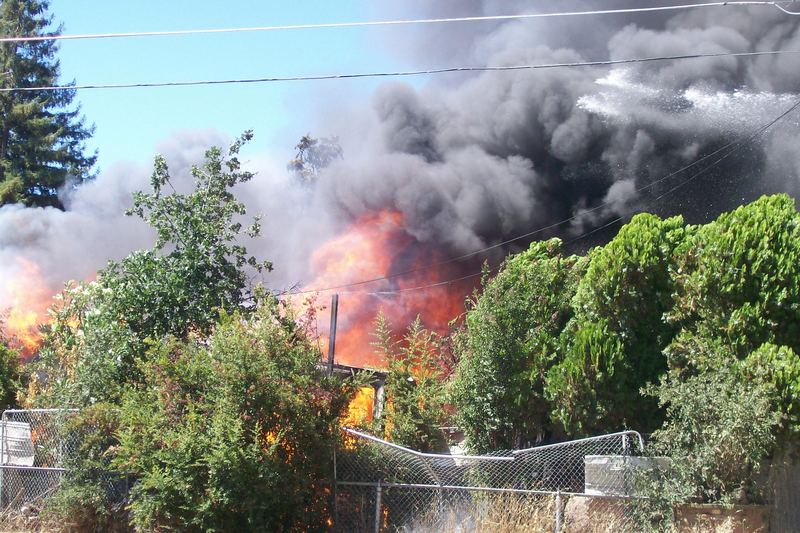 House with smoke rising during a structure fire